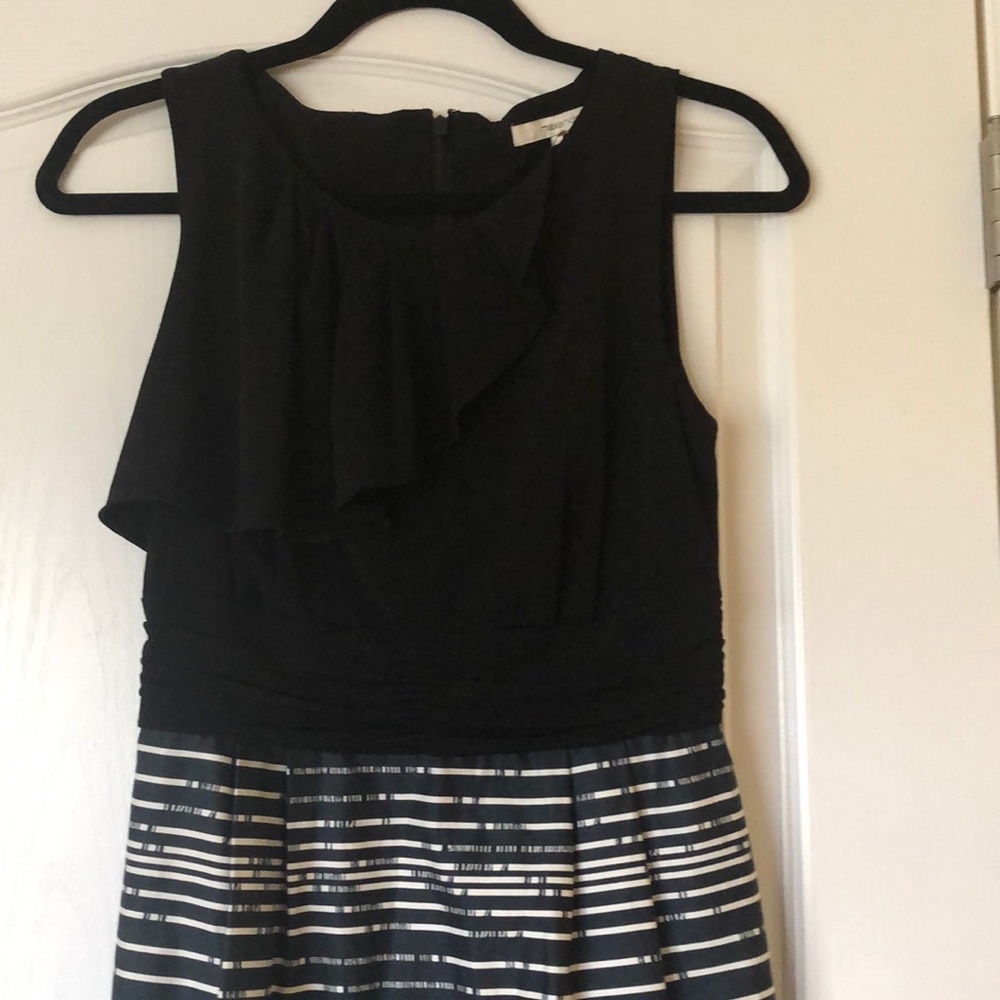 sleeveless black and white dress with ruffle.